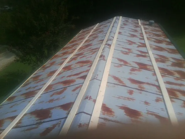 Rusted metal roof panels with new wood purlins before replacement — Storm Damage Roof Repair in Delphi Falls by Roofing Brothers